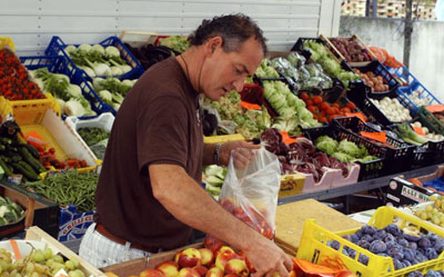 Sandro Saccon fills a bag with a customer’s order.