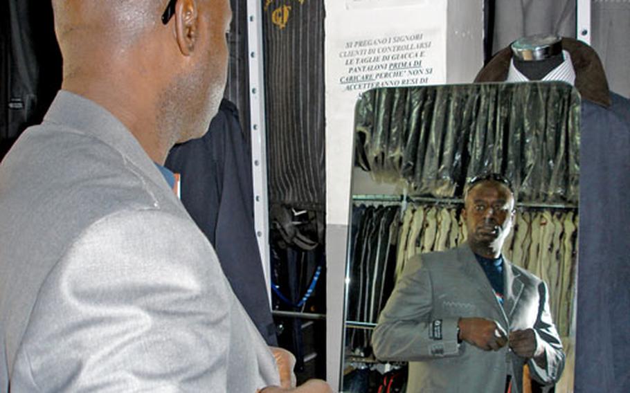 Terry Vick tries on a suit at the GF clothing shop in downtown Naples.