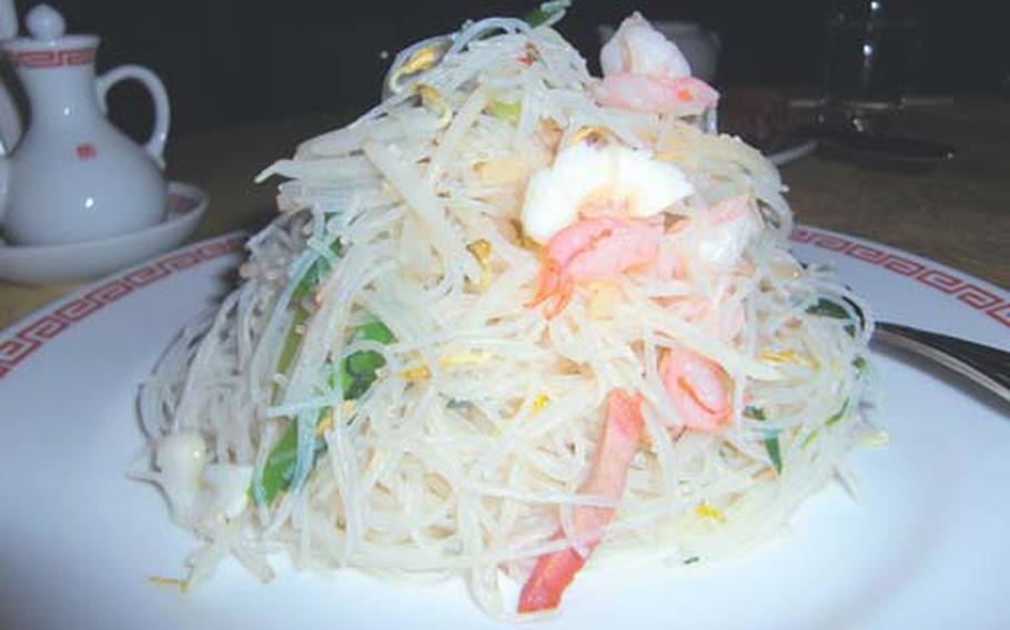 Snow white rice noodles garnished with seafood and vegetables.