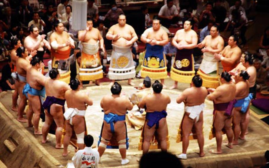 Sumo wrestlers in the senior division step into the ring wearing their intricately designed aprons or “kesho-mawashi” during the makuuchi wrestlers ceremonial entrance at the Ryogoku Kokugikan arena in Tokyo on the eighth day of the 15-day tournament — “basho” — on Sept. 20.