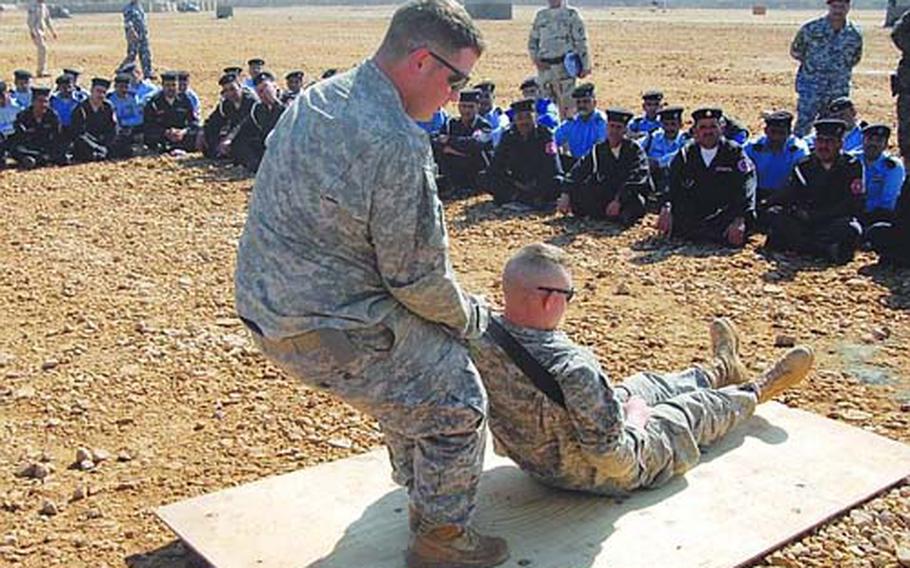 First Lt. Richard E. White, a Company C, 172nd Support Battalion physician assistant, examines Spc. Jimmy Wisz, of Headquarters and Headquarters Company, 2nd Battalion, 28th Infantry Regiment, at Forward Operating Base Kalsu, Iraq, in May.