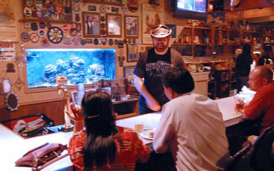 My Place owner John Chamberlain chats with customers on a Saturday night in Misawa, Japan.