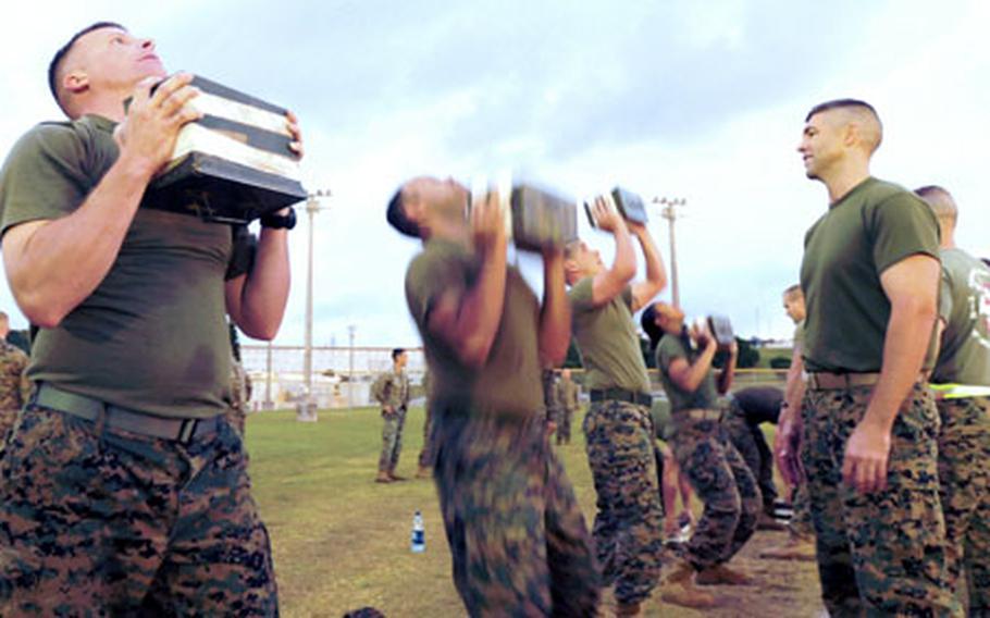 Marines perform the ammunition-can llift during the combat fitness test at Camp Foster, Okinawa.