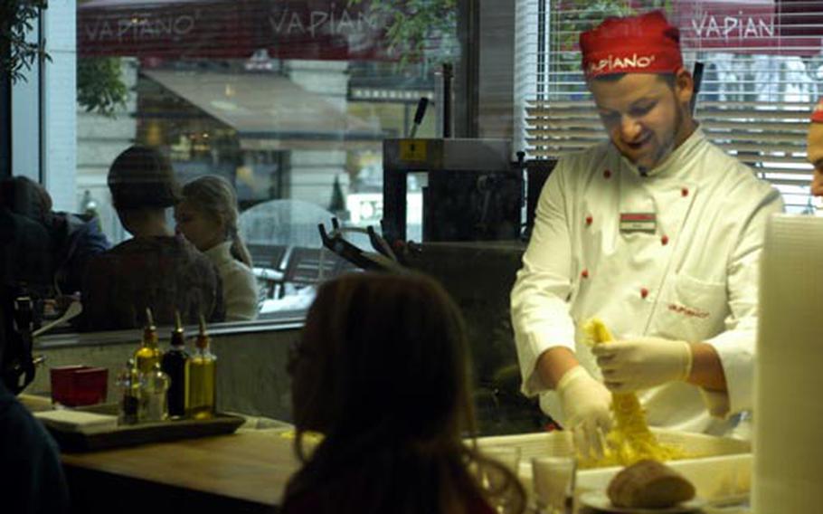A Vapiano employee prepares pasta. “Freshness, transparency and beauty of design are the three things I would say draw people here,” said Michael Schlarmann, franchisee of the Wiesbaden Vapiano.