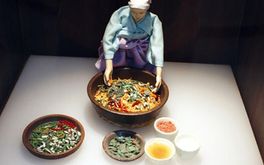 This model depicts a Korean preparing kimchi.