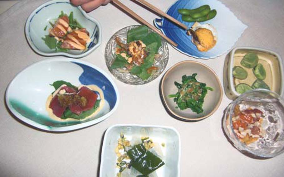 A diner at Kappou Dining Kamekichiya enjoys a variety of appetizers made with fresh seasonal ingredients. The restaurant is located in the Onishi Terrace Housing area in Kitanakagusuku, Okinawa.