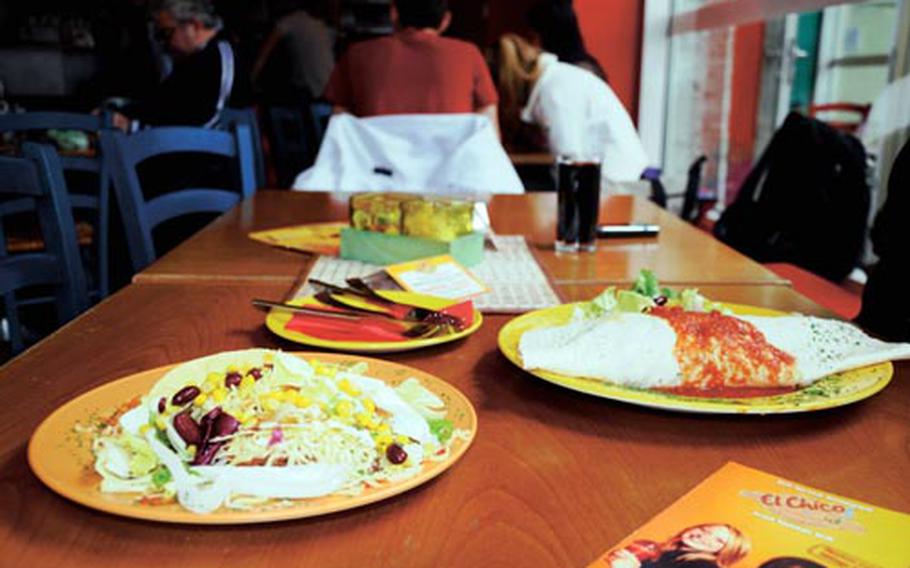 A plate of tacos and a burrito supreme await customers at El Chico. Both dishes pictured cost about 6 euros.