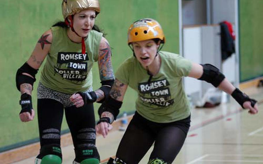 Romsey Town Rollerbillies teammates Katherine Anders, left, and Sarah Sole practice maneuvers during a training session in Cambridge, England.