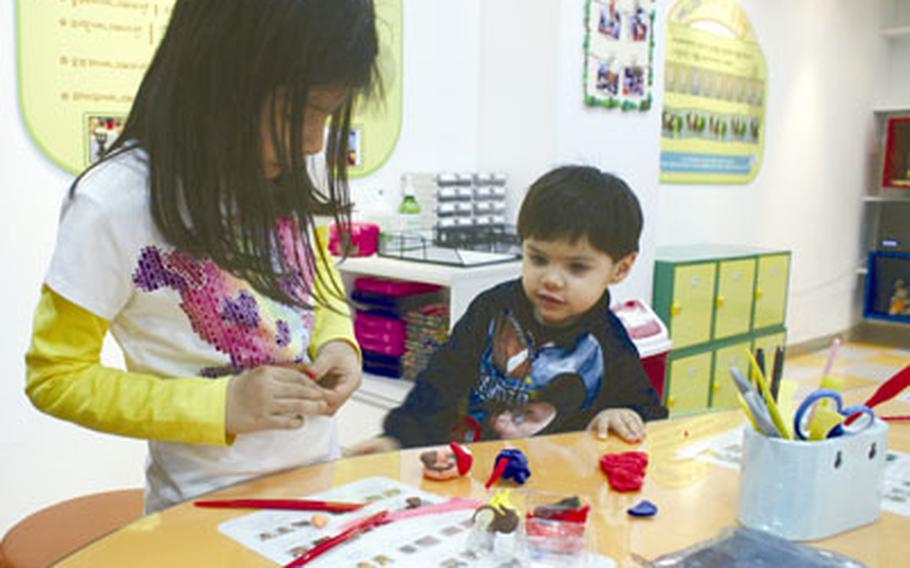 Natalya and Diego Jimenez create characters using clay from the Character Hall at the Seoul Animation Center.