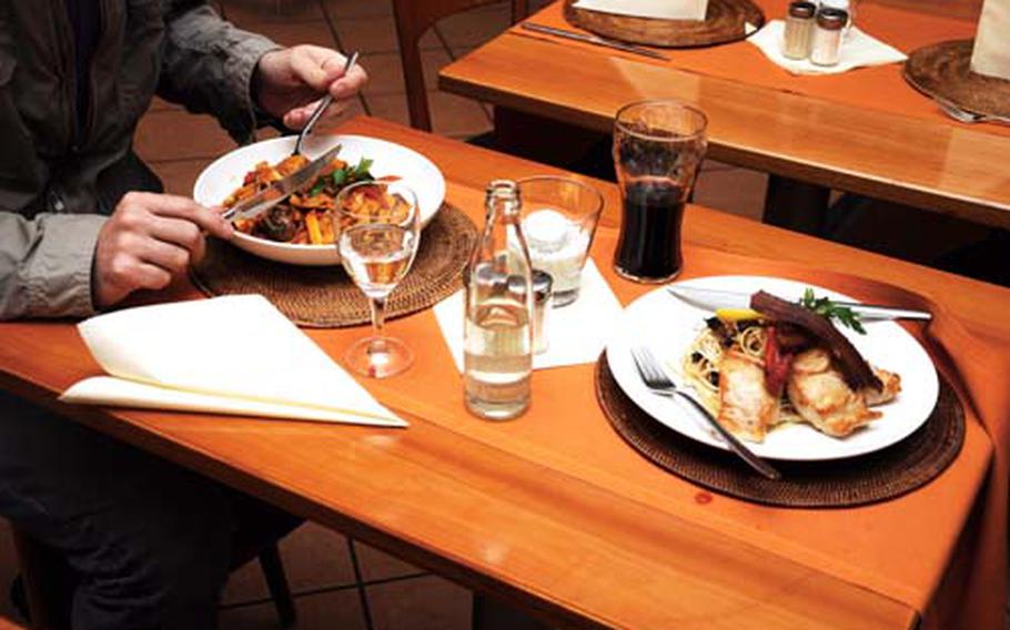 A patron at Sydney’s Australian Bar and Restaurant takes his first forkful of Australian Noodles with Vegetables and Grilled Kangaroo. Across the table, the hungry photographer’s Crocodile Hunter dish awaits.