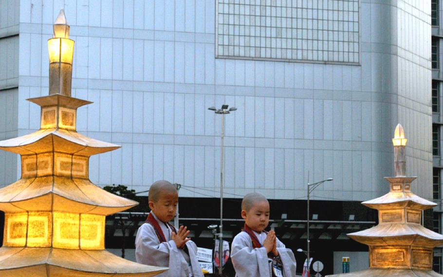 Two boys pay homage to Buddha in the 2010 Lotus Lantern Festival parade on May 16 in Seoul. The annual festival celebrates Buddha's birthday.