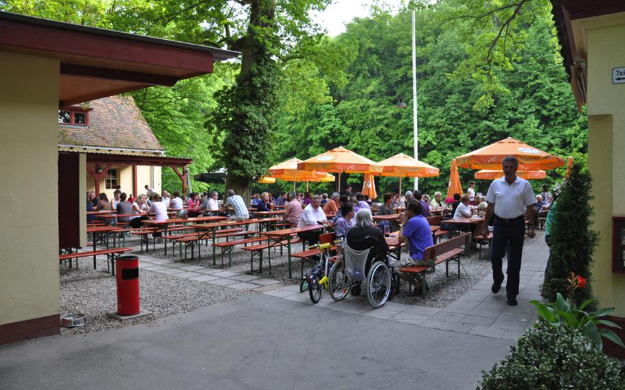 The beer garden and restaurant Bootshaus in Bamberg, Germany, offers a shaded seating area along with a variety of German dishes and cold brew.