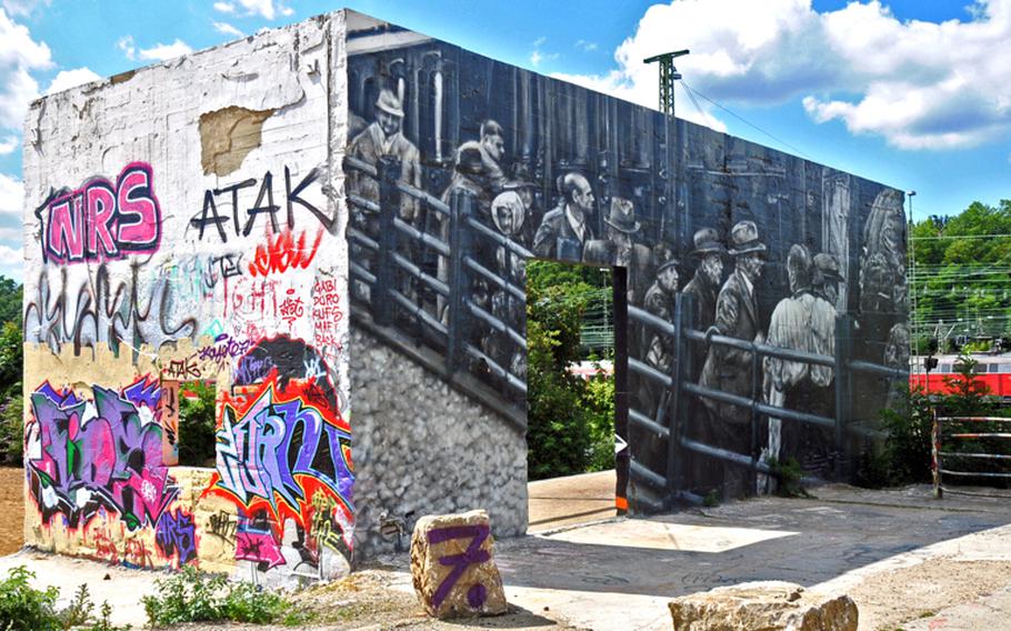 This large mural on the walls of a U-shaped structure has been stripped, cleaned and painted over by its original artist, known as Jorkar 7. It shows the deportation of Jews from Wiesbaden, Germany, in 1944, based on a photograph taken by a city policeman. The stark black-and-white work stands out among the colorful graffiti at the Schlacthof, the city's former slaughterhouse district. The finished work will be part of a park that is still being created.