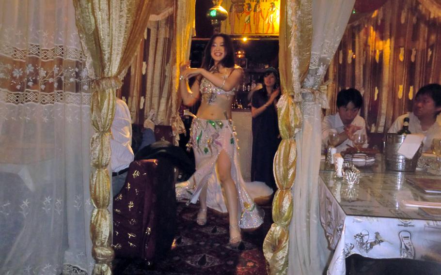 A belly dancer entertains guests as they dine at Nefertiti Tokyo.