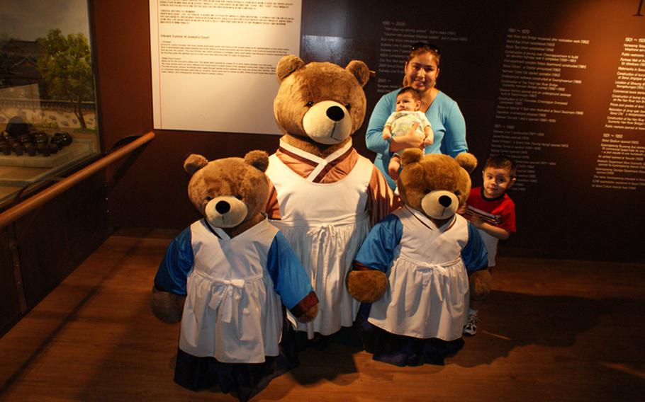 Julia, Rafael and Diego Jimenez pose with a teddy bear and two cubs during a visit to the Teddy Bear Museum.