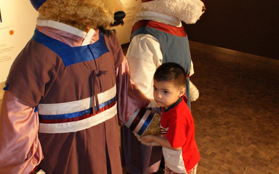 Diego Jimenez, 3, shakes hands with a teddy bear during a visit to the Teddy Bear Museum.