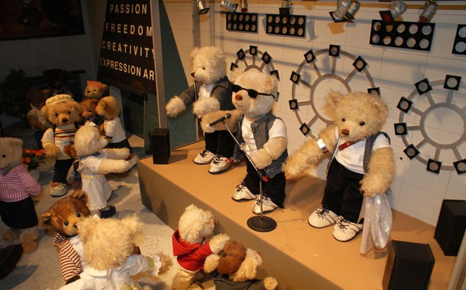 In this display at the Teddy Bear Museum, bears perform in front of a crowd at Dongdaemun, the fashion mecca of Seoul and a popular tourist spot.