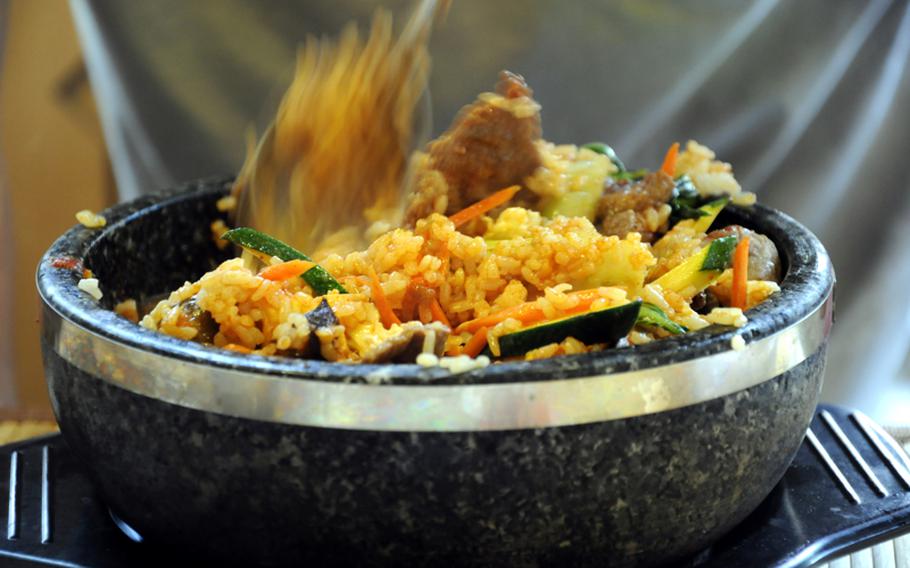A dish of bibimbap, a traditional Korean, dish made with beef, rice, egg and vegetables, awaits a hungry reporter  at Eat Drink, Man Woman in Stuttgart, Germany, on Tuesday, June 29.