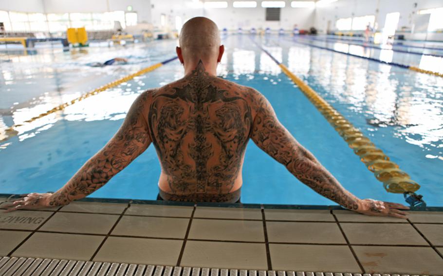 Mike Lilly, a military dependent at Yokota Air Base, Japan, shows off his tattoos. Lilly is unable to enter water parks in Japan because of his tattoos.