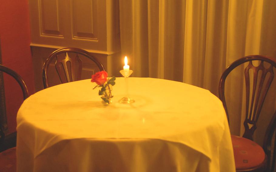 A rose and a candle decorate a table at Simplicissimus, which, translated from Latin, means 'very easy.'