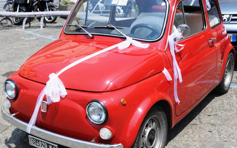 A classic Fiat 500 is decorated for a bride and groom who tied the knot one Saturday afternoon in July.