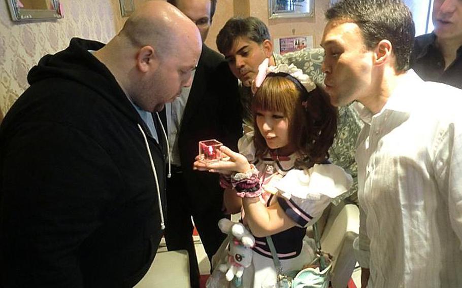 Upon leaving the Mai Dreamin maid cafe in Akihabara, party members blow out a candle signifying the end of the dream. Clockwise from left: Tim Boisvert, Peter Smith, Bryan Koslow, David Heath, and Josh Porter.