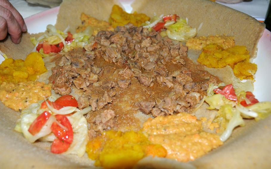 A typical meal at Mar Rosso includes stewed meat, potatoes, lentils and salad served atop several pieces of ingera bread.
