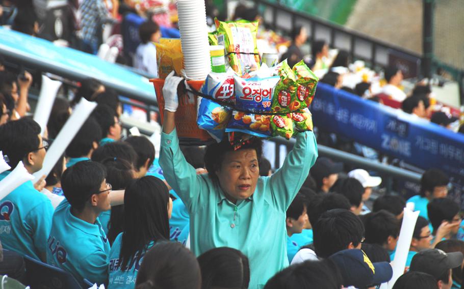 A vendor sells snacks and drinks during a professional baseball game at Seoul&#39;s Jamsil Stadium.