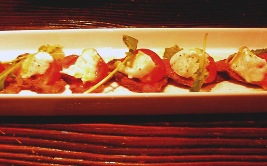Tender slices of wagyu beef, served caprese-ctyle with cherry tomatoes and mozzarella, reflects a Japanese influence on traditional Italian cuisine at Mingo restaurant in Tokyo.