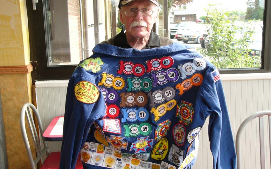 Frank Miller shows off a jacket that records the 48 one-day, 100-kilometer Volksmarches he's completed since 1975.