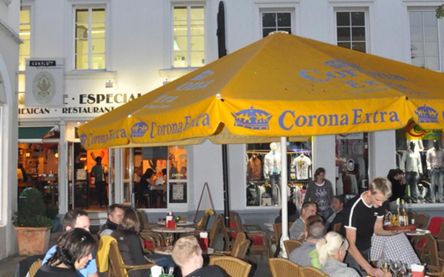 Golden Corona umbrellas distinguish Café Especial from the surrounding restaurants in the heart of Saarbrücken's St. Johannes Markt.