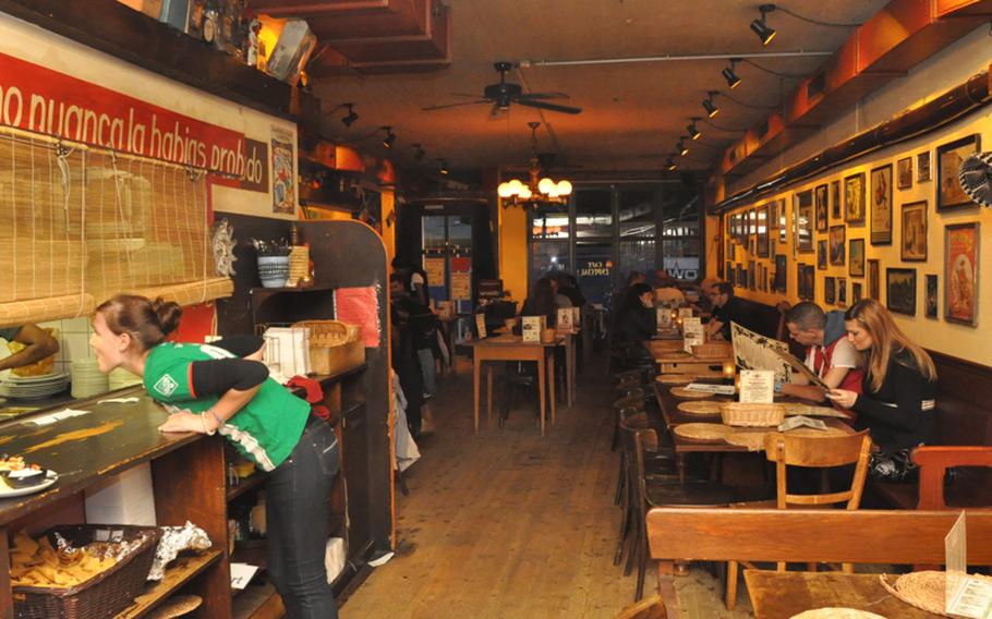 Rows of tables inside Café Especial in Saarbrücken, Germany, are surrounded by a pastiche of south-of-the-border kitsch.