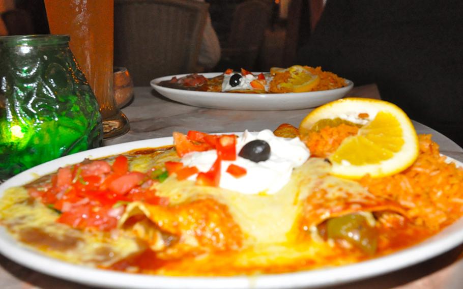 The enchiladas at Café Especial in Saarbrücken, Germany, are so large that it is hard to tell where the tortilla ends and the mass of rice and refried beans begins. The entire dish is topped with freshly melted Monterey Jack cheese.