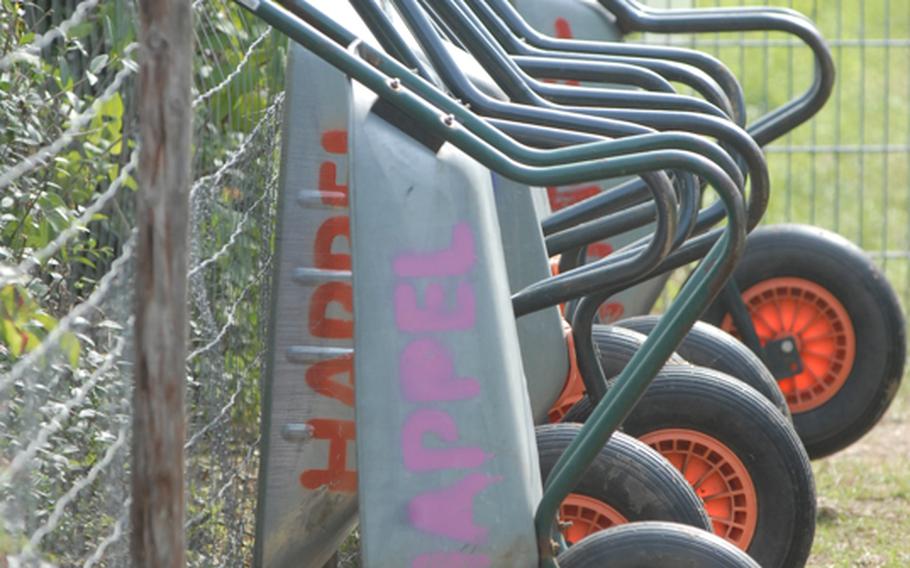 Wheelbarrows line the fence of the Appel Happel farm near Mainz, Germany. There is no charge to use the farm's wheelbarrows.