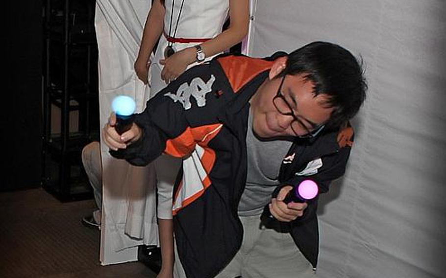 A visitor to the Tokyo Game Show 2010 tries out the new PlayStation Move motion controller on Saturday.