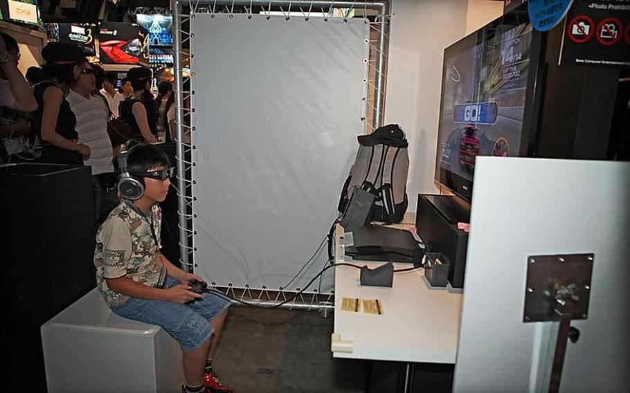 A young gamer samples one of PlayStation's new 3-D titles Saturday at the Tokyo Game Show 2010 held at Chiba Prefecture's Makuhari Messe convention center.