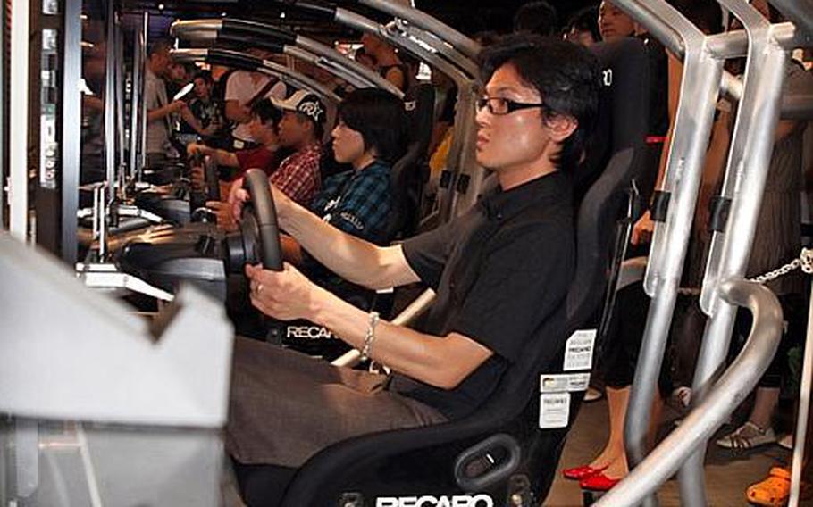 A gamer takes Gran Turismo 5 out for a spin Saturday at the Tokyo Game Show 2010.