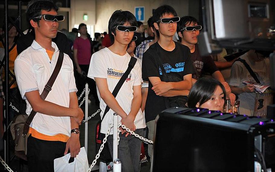 Fans wear 3-D glasses while they check out a collection of PlayStation 3 games to be released throughout the year.