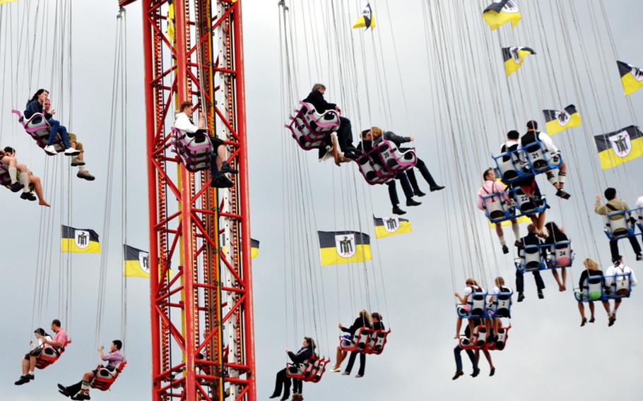 Festival goers ride a swing ride on the fairgrounds of Oktoberfest in Munich on the first day of the festival. Beer tents are surrounded by carnival rides to make the festival more than just a beer drinking event.
