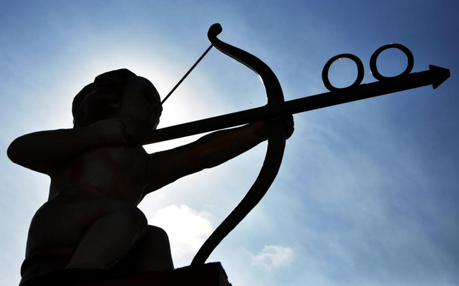 A statue of a cupid aims toward restrooms on Theresienwiese, the Oktoberfest grounds, in Munich. Toilets are located next to each beer tent at the festival.