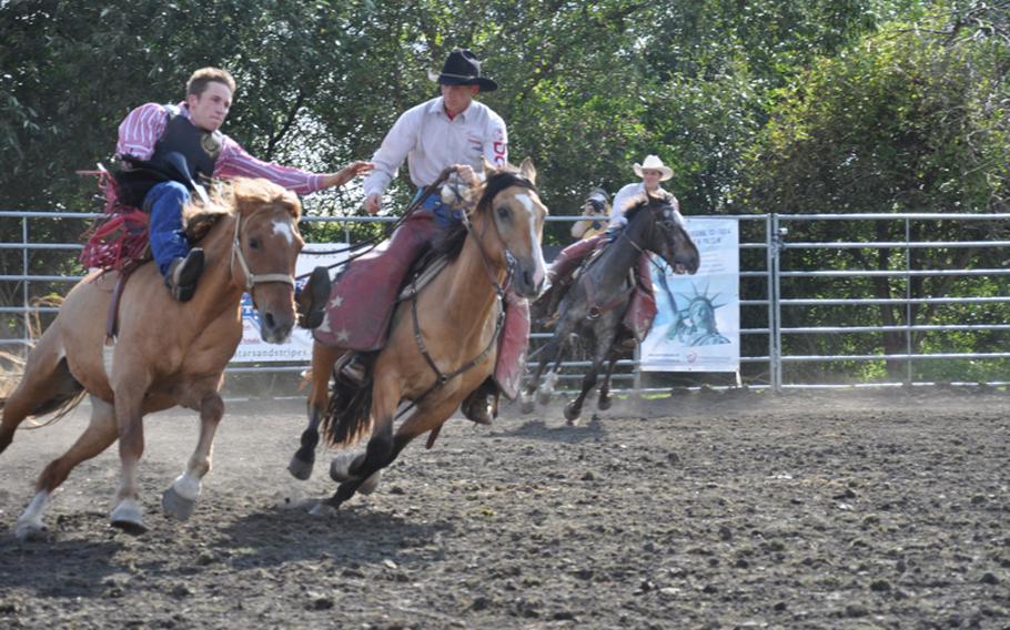 German Patrick Göschel attempts to jump from Mustang Sally after finishing his ride a rodeo event Sept. 4 in Russheim, Germany.