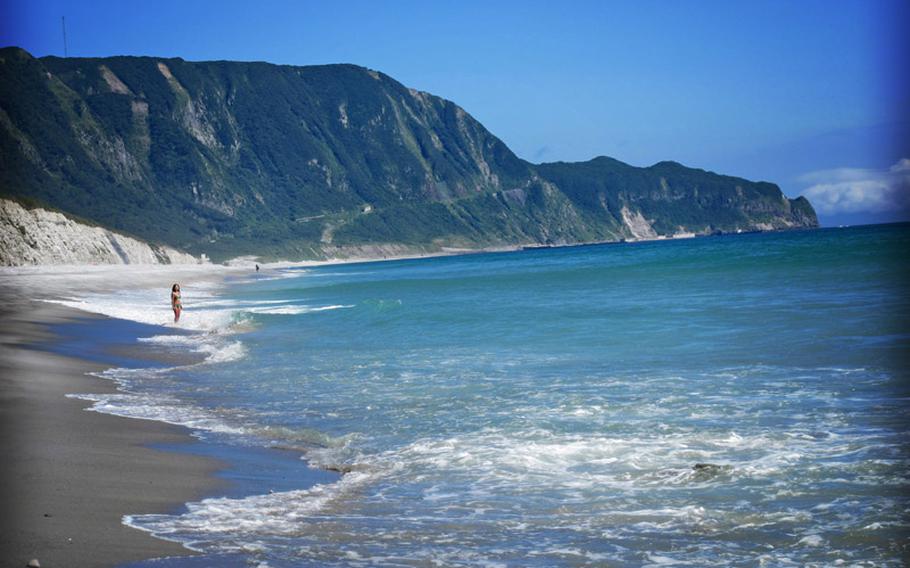 A traveler enjoys the pristine waters of Habushiura beach on Niijima. I recently took a trip to the island, which is a part of a group of volcanic islands that stretches across the Izu peninsula and is considered a part of Tokyo even though you have to fly or take a boat to get there.