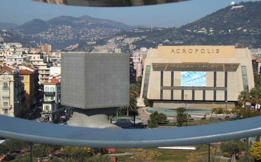 The terrace of the Museum of Modern and Contemporary Art offers splendid views of Nice, France.  Seen here are the Acropolis Convention Center and the 'Square Head,' a monument-sculpture that is a symbol of the city's contemporary architecture.
