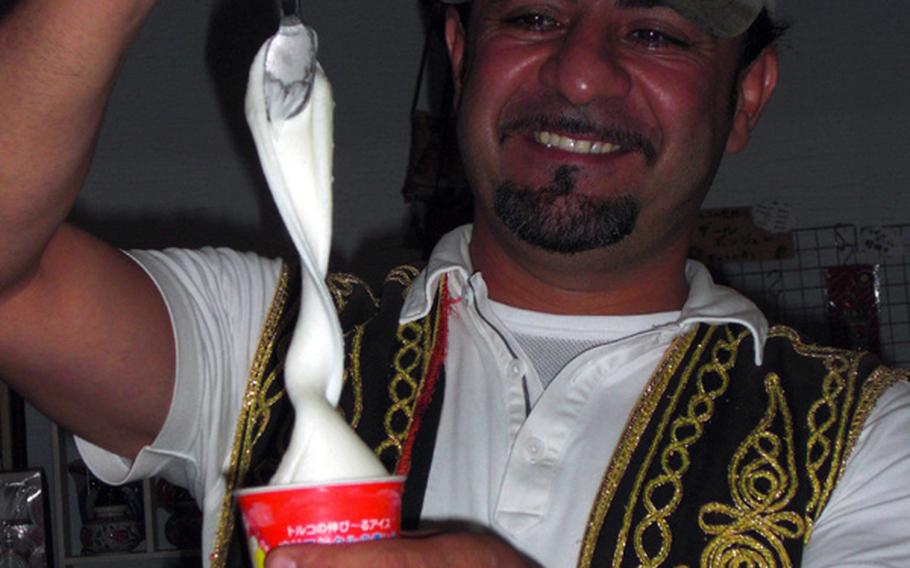 Askin Antonio Yildirum, owner of Okinawa's Istanbul Kebab House, shows how to properly churn the famed Turkish ice cream. Developing elasticity is the key to adding sweetness to the rich, flavorful ice cream.