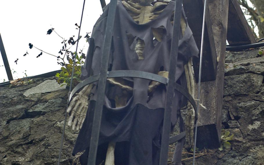 A skeleton looks down on visitors from a cage at Burg Frankenstein's Halloween 2009 exhibit.