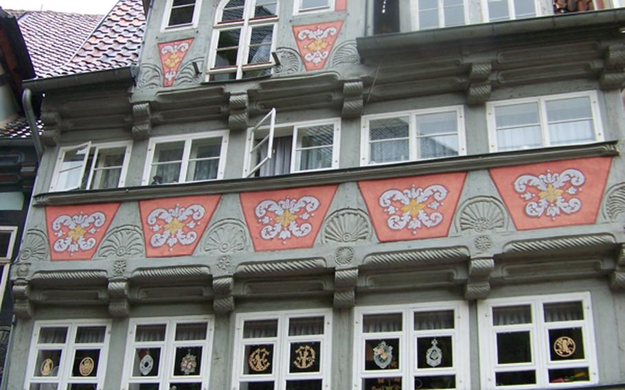Eye-catching  carvings, paintings, columns and roof tiles decorate a storefront facing the main square of Quedlinburg. The building houses a souvenir shop.