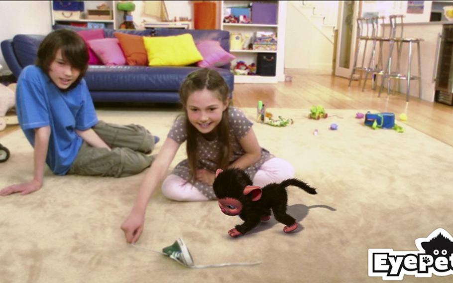 'EyePet' lets you adopt catty/monkey thingy as your digital pet. It appears on your TV screen along with you and your living room.