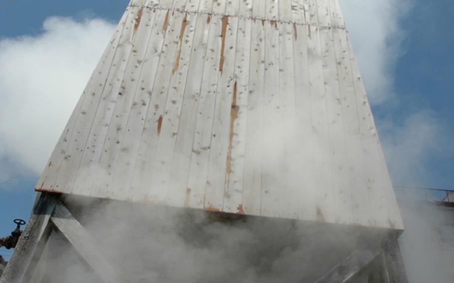 Onsen hot water spews inside a wooden tower covered with steam in Atagawa Onsen town.