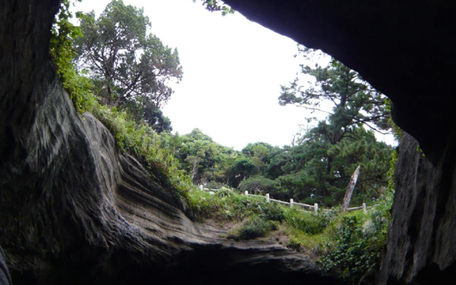 The ceiling of a cave fell in long ago, creating a view of the sky in the roof of an island at Dogashima. The cave has been designated as a national monument.