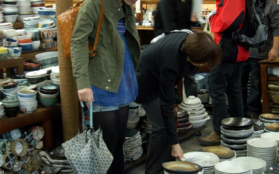 Shoppers scout for good buys among the various plates available at Kappabashi.